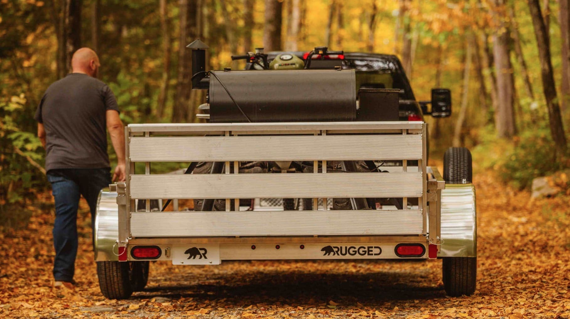 Loaded Rugged utility trailer secured for transport