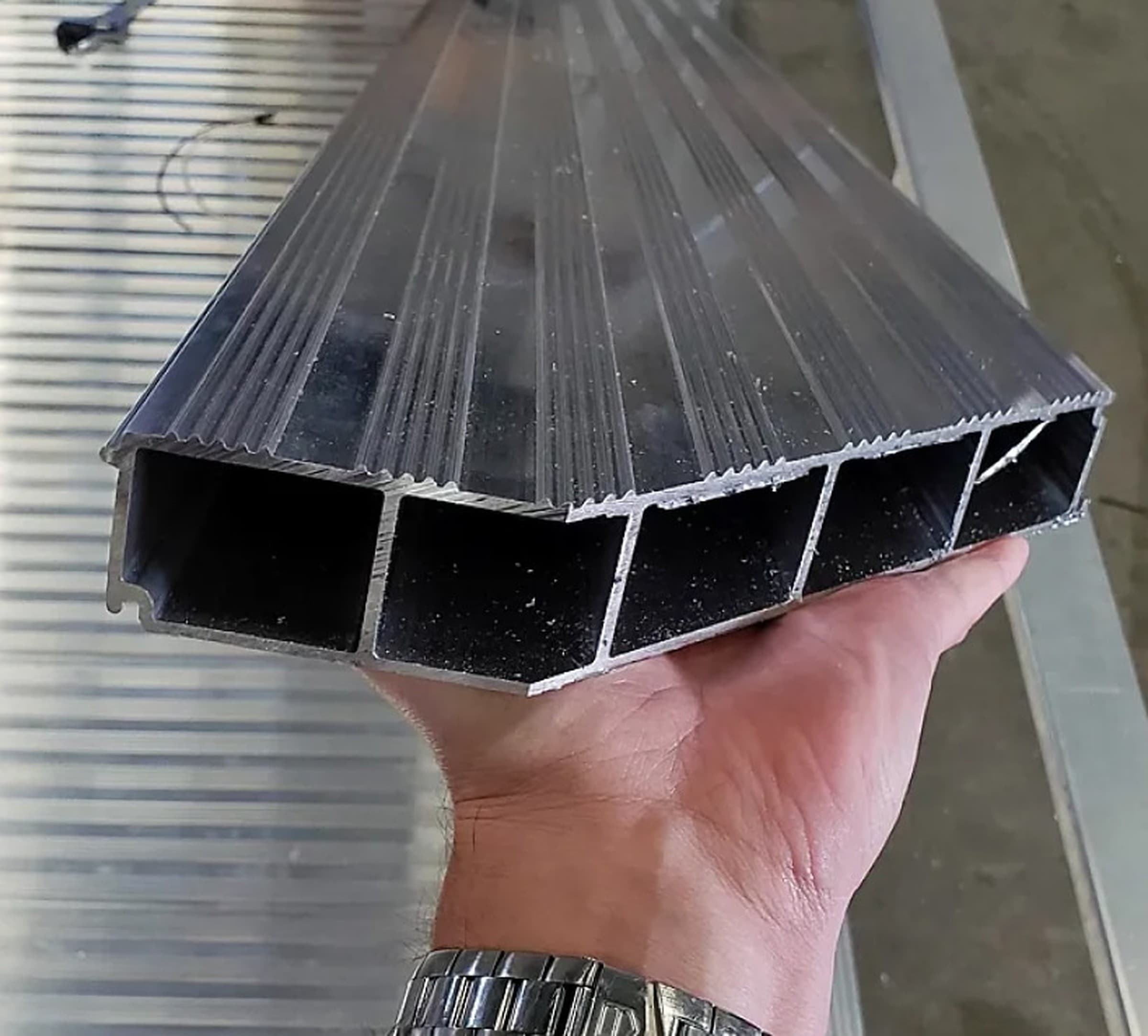 Close-up of an extruded aluminum trailer deck showing the interlocked plank surface.