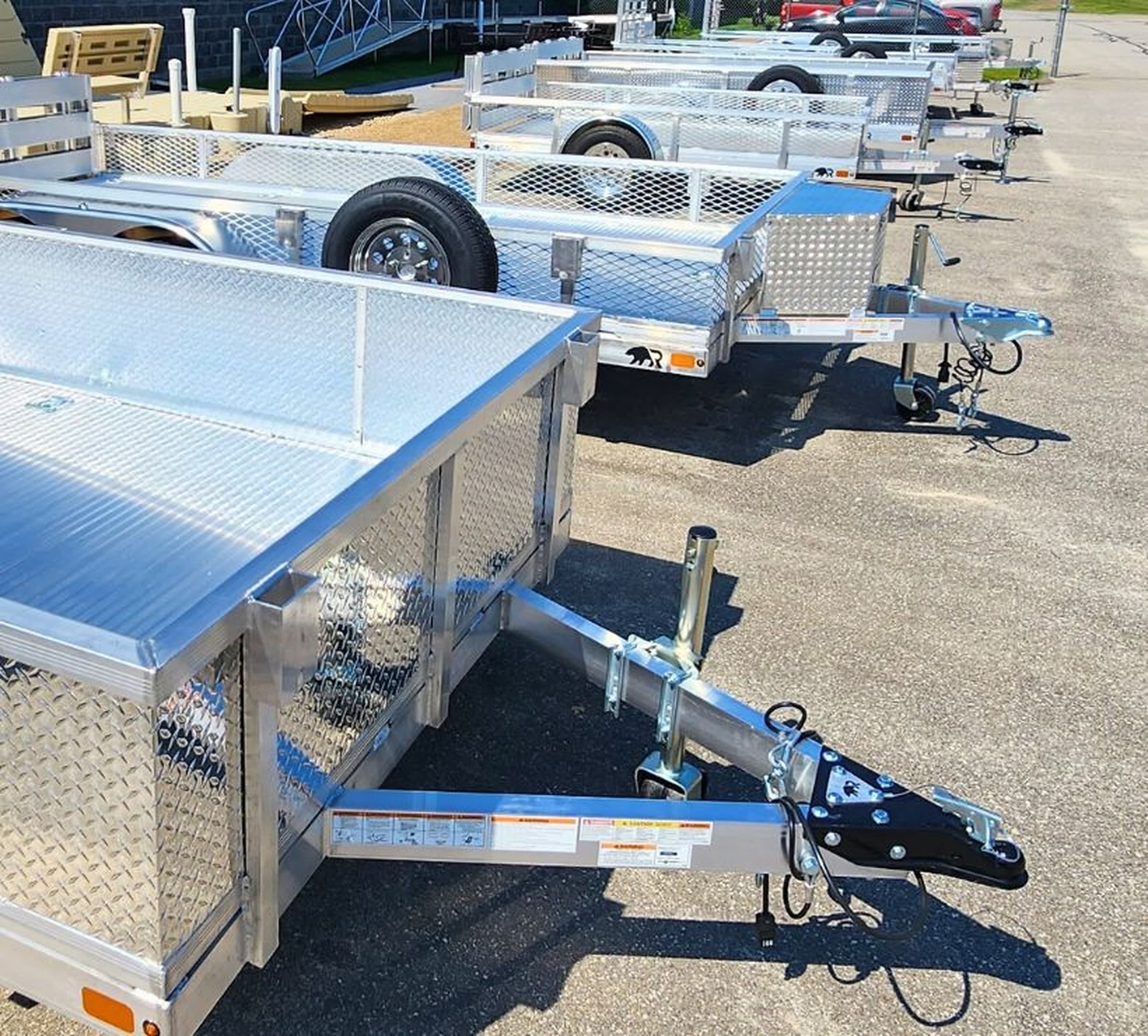 Reference grid of Rugged utility trailer rail options showing open rail, mesh, and tread-plate styles at different heights.