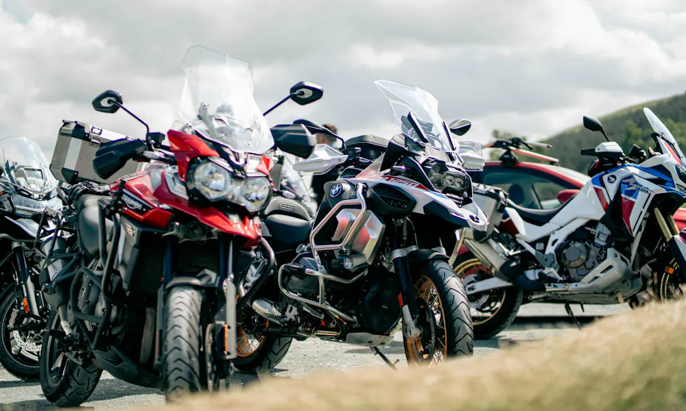Adventure motorcycles parked together outdoors.