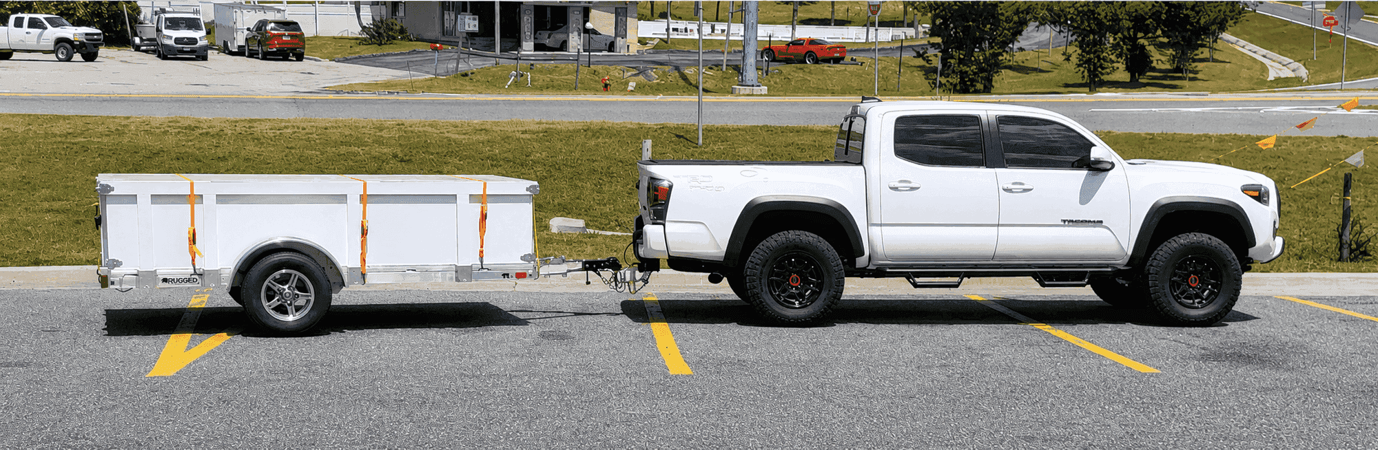 Rugged 5 × 10 utility trailer with the solid side kit, hitched to a Toyota Tacoma