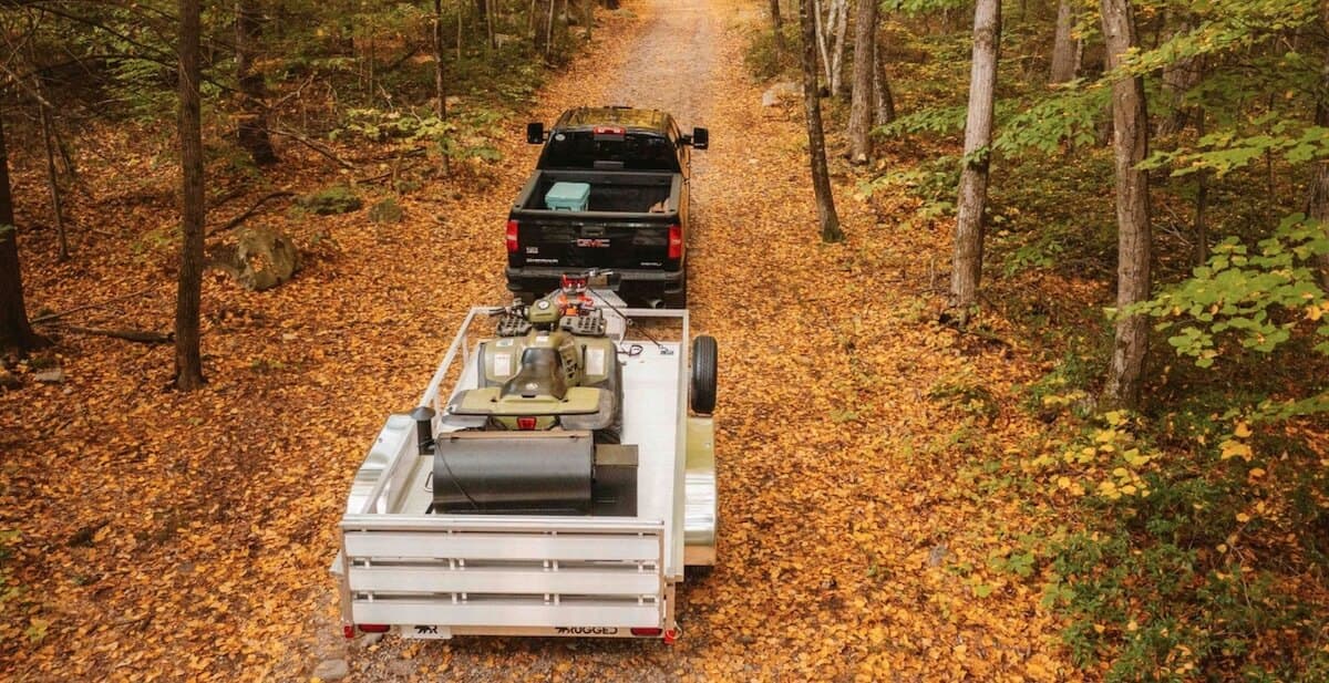 Rugged utility trailer being towed on a fall road — representative lineup shot pending