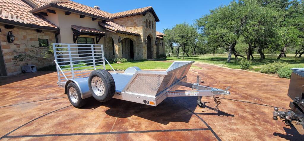 trailer with tread plate side rails parked in a driveway