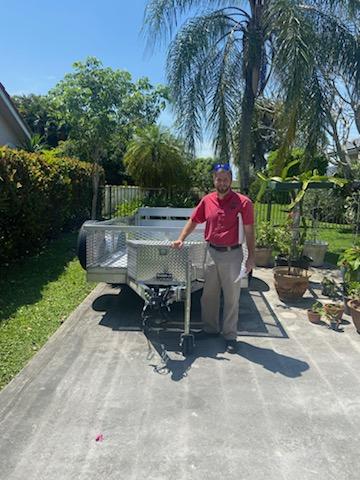 Patrick T standing next to trailer outside