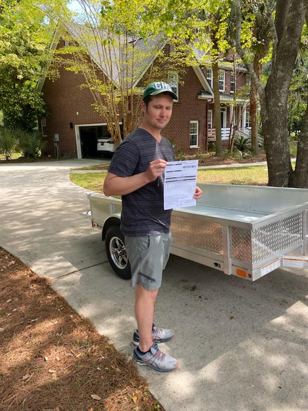 David H standing next to trailer in driveway