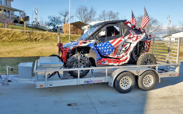 vehicle with American flags on it on a silver trailer