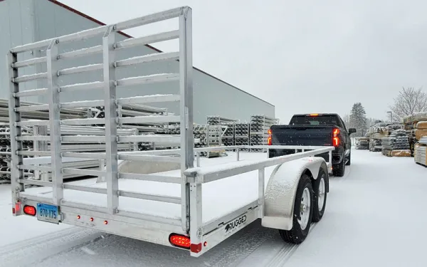 truck pulling an aluminum trailer in the snow