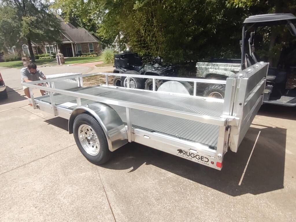 trailer with side rails parked in a driveway