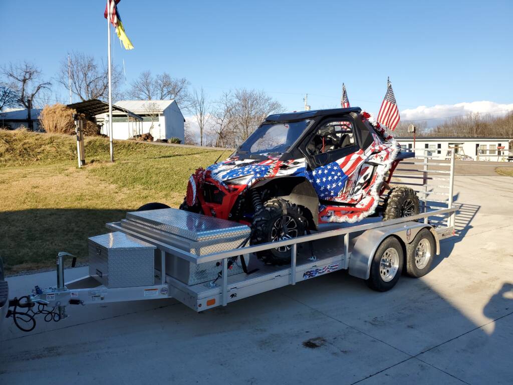 vehicle with American flags on a trailer