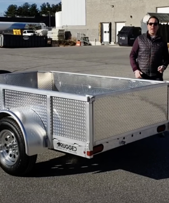 5' x 8' Utility Trailer parked outside with a man in the background