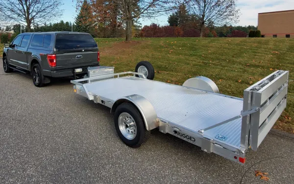 ford truck pulling a silver utility trailer