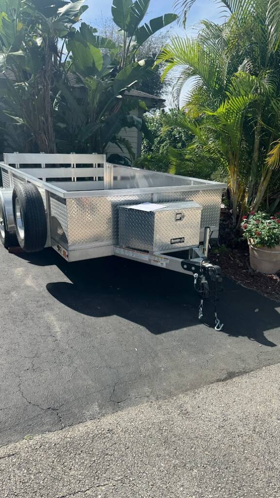 trailer with tread plate side rails parked in a driveway