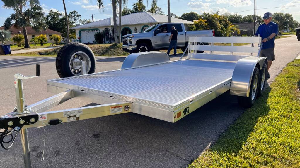 man standing behind a silver trailer